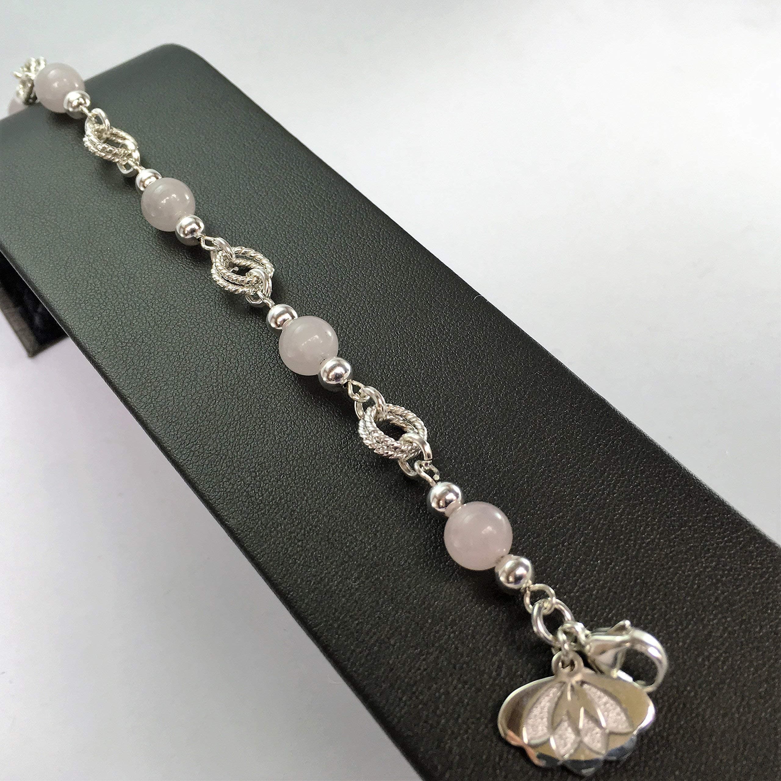 silver bracelet, with twist rings and round rose-quartz beads for women. Medium size